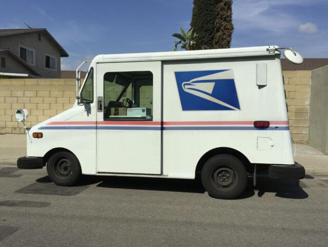 Feds: mailman stashed mail in car, garage