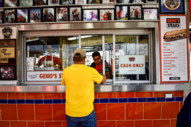 Geno’s sign comes down, but immigrants aren’t quick to forgive