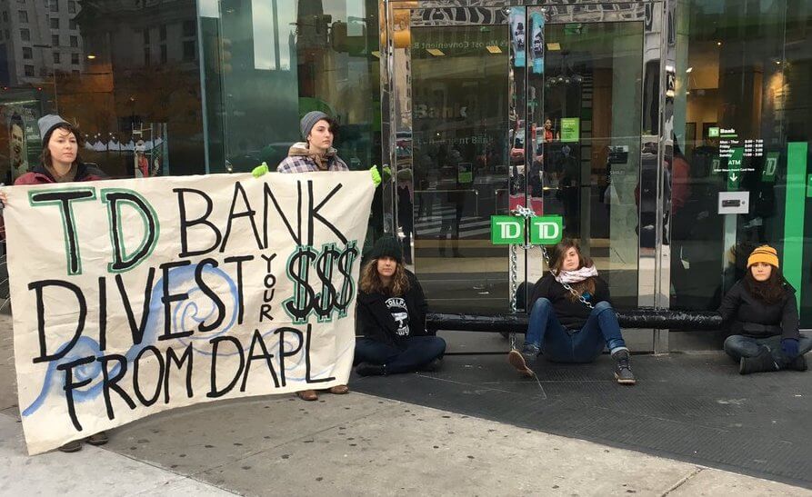 Four detained by police after chaining themselves to Philly bank to oppose