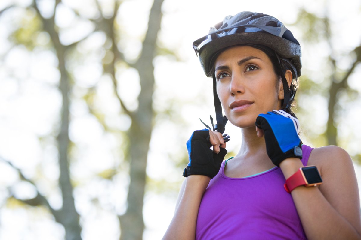 Female athletic wearing bicycle helmet