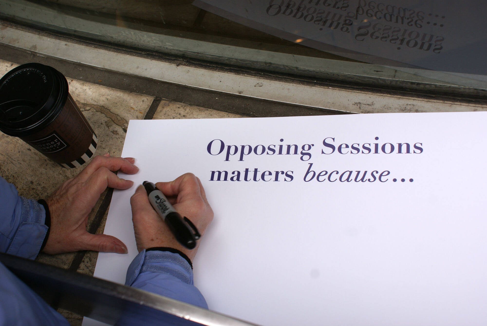 |<image-caption>
<p>A member of the #TuesdaysWithToomey group fills out a sign with reasons Sen. Toome|Alexis Sachdev” title=”|<image-caption>
<p>A member of the #TuesdaysWithToomey group fills out a sign with reasons Sen. Toome|Alexis Sachdev” /></div>
<p><!-- END scald=2782 --></div>
</div>
<p>That responsibility now rests with Bandy, who has vowed to stand outside Toomey’s office every Tuesday for the next six years, each week armed with a different issue.</p>
<p>Toomey’s office is less predictable. In early gatherings, staffers invited the group up to their office, and facilitated discussion. But last week, activists were locked out of Eight Penn Center, the high-rise that houses Toomey’s 17th-floor office. According to Bandy, Toomey’s office was closed that afternoonand staffers didn’t accept letters activists had written.</p>
<p>“Last week, Senator Toomey’s staff was committed elsewhere at that time,” press secretary Steve Kelly told Metro in an email. “Staff notified the group of the situation in advance and offered a meeting at another time.”</p>
<p>Kelly also said Toomey’s staff has met with the Tuesdays with Toomey group several times in recent months, and said they are happy to continue doing so, “as issues warrant.”The senator, Kelly added, is in Washington during the gatherings.</p>
<p>This week, a Philadelphia Police Department civil affairs officer facilitated the exchange of more than 50 letters to Toomey’s camp. But again, the crowd was locked out of the building.
<p>Bandy, a diligent caller to Toomey’s eight offices, doesn’t want just a standard response —not like she’s received one yet. She, and many others who gather at the senator’s Center City office, are demanding more.</p>
<div class=