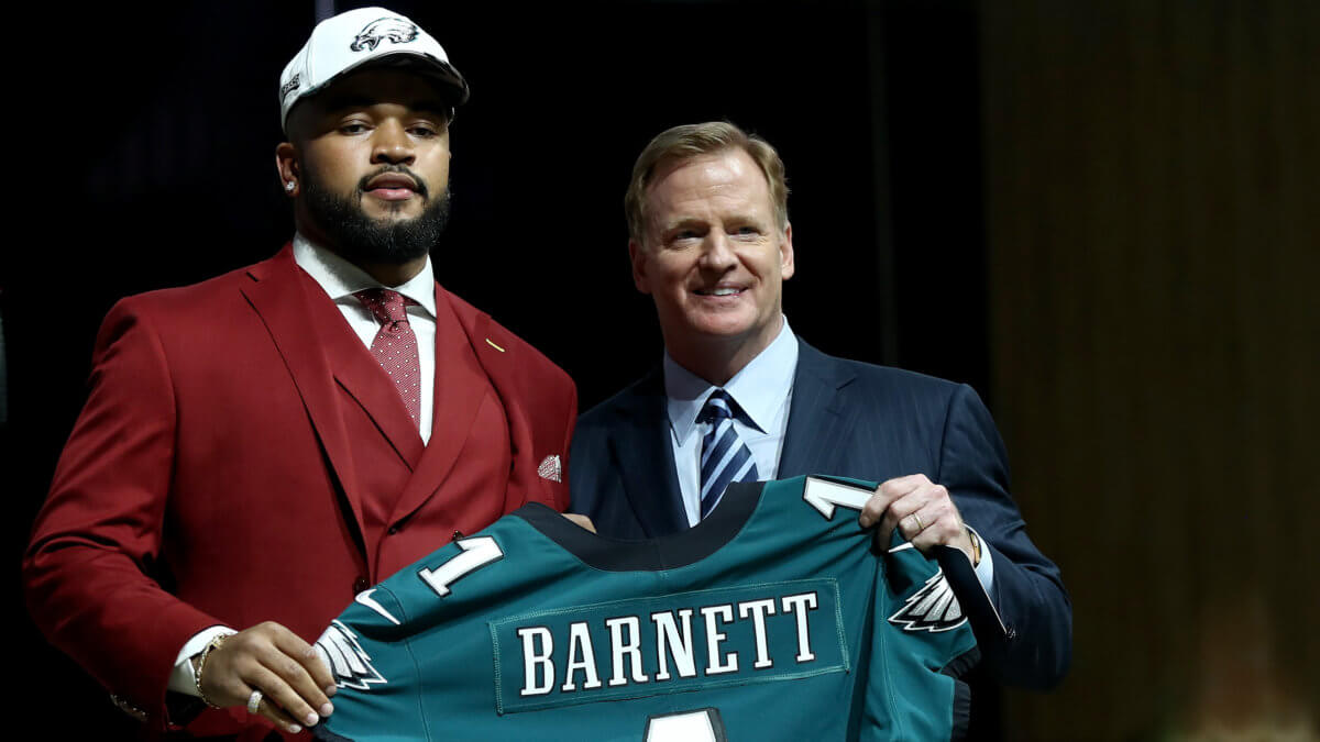 Derek Barnett holds his Eagles jersey with NFL Commissioner Roger Goodell at the 2017 NFL draft. (Getty Images)