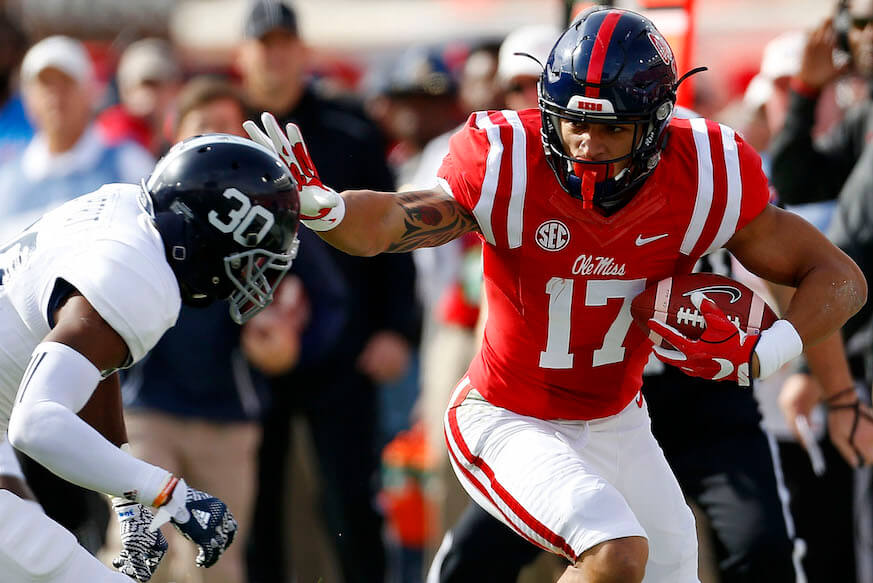 Ole Miss tight end Evan Engram stiff arms a defender.