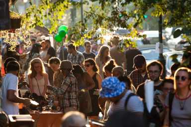 Thousands of people gather to stroll along Baltimore Ave. and check out all the deals. | Photo by Ryan Collerd, courtesy of University City District.