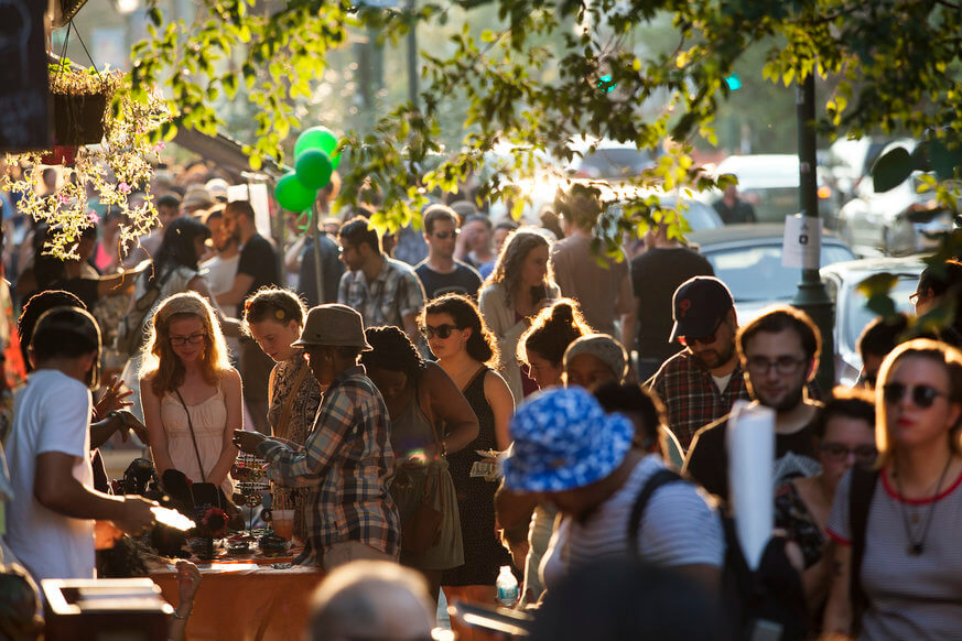 Thousands of people gather to stroll along Baltimore Ave. and check out all the deals. | Photo by Ryan Collerd, courtesy of University City District.