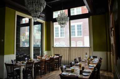 Osteria has a few different event spaces available for holiday parties, including the wine room. | Provided