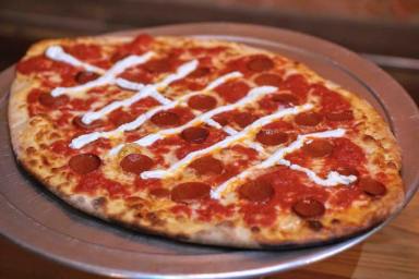 The football-shaped pizza at SLiCE definitely scores a touchdown in our book. | Provided