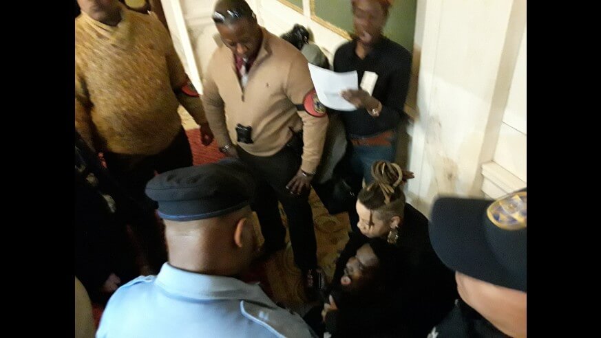 Abdul-Aliy Abdullah Muhammad is surrounded by authorities. (Image: Michael Butler)