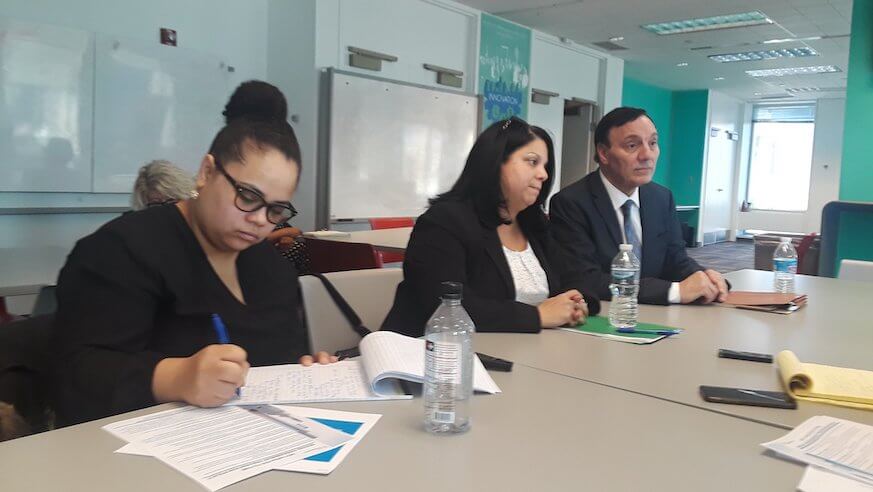 Monica Marchetti-Brock (center) and William Twardzik of the Office of Labor Relations discuss changes to sexual harassment policy.