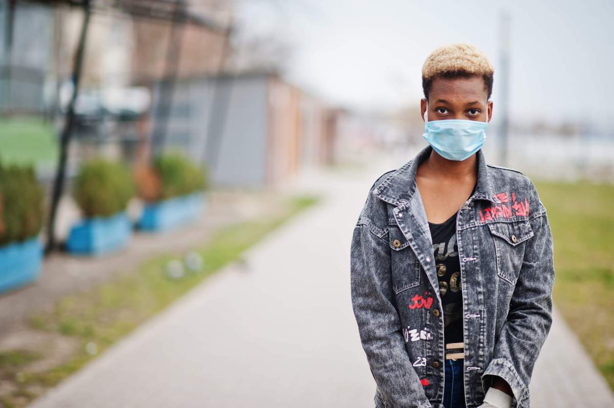 African girl at park wearing medical masks protect from infections and diseases coronavirus virus quarantine.