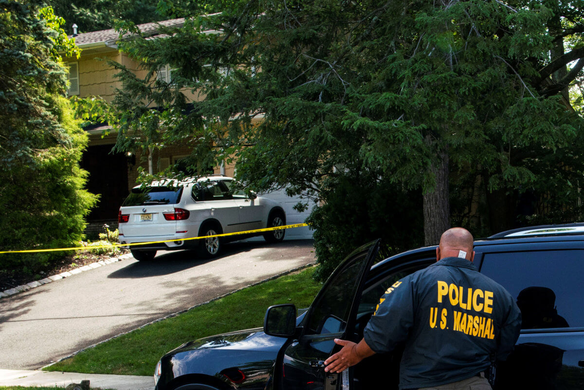 Law enforcement officials are seen outside the home of federal judge Esther Salas in North Brunswick, New Jersey
