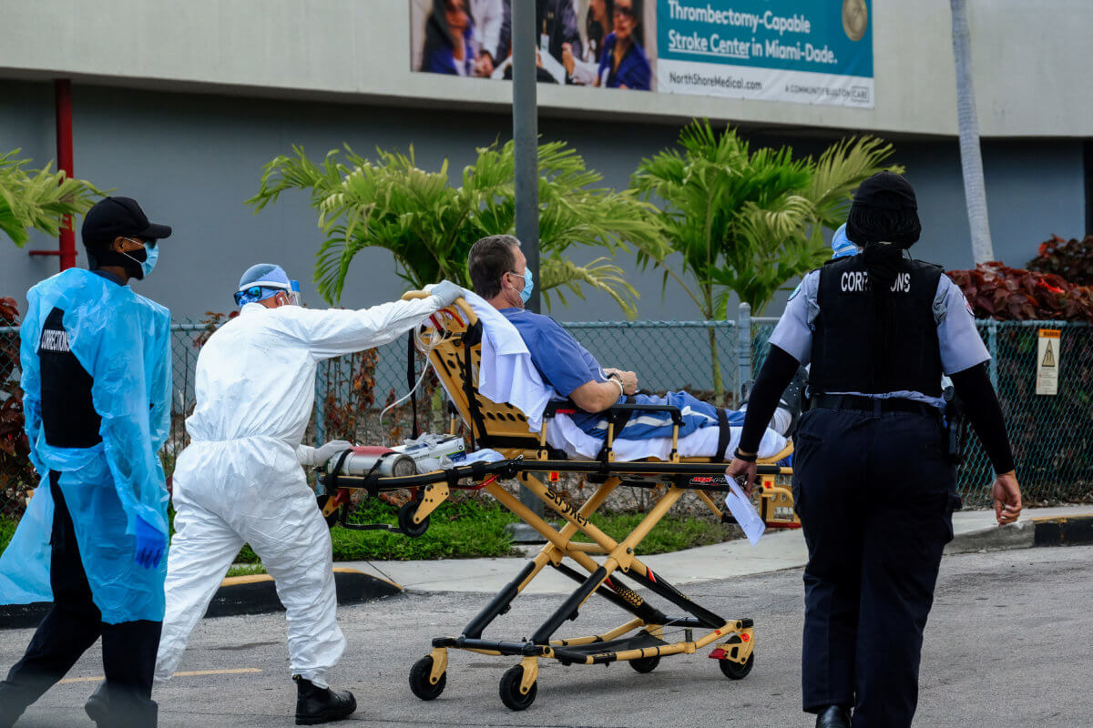 Emergency Medical Technicians (EMT) arrive with a correctional patient at North Shore Medical Center where the coronavirus disease (COVID-19) patients are treated, in Miami