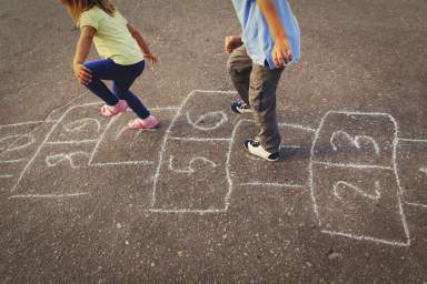 kids playing hopscotch on playground