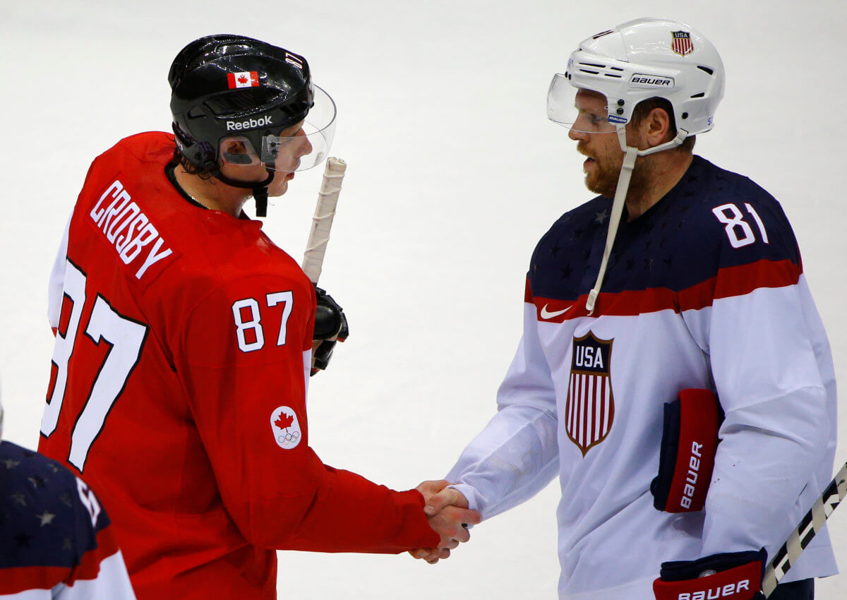 Canada’s Crosby shakes hands with Team USA’s Kessel after Canada won their men’s ice hockey semi-final game at the 2014 Sochi Winter Olympic Games