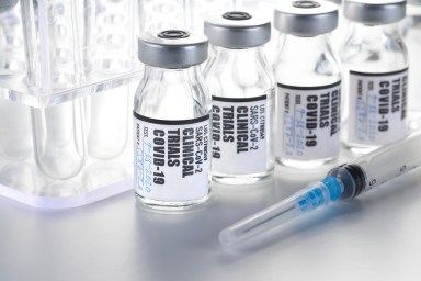 Clinical Trial – Vaccine: Covid-19, Coronavirus in vial with syringe on white background