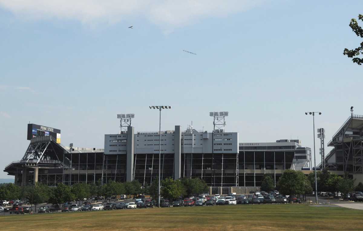 An airplane towing a banner flies over the Penn State campus in State College, Pennsylvania