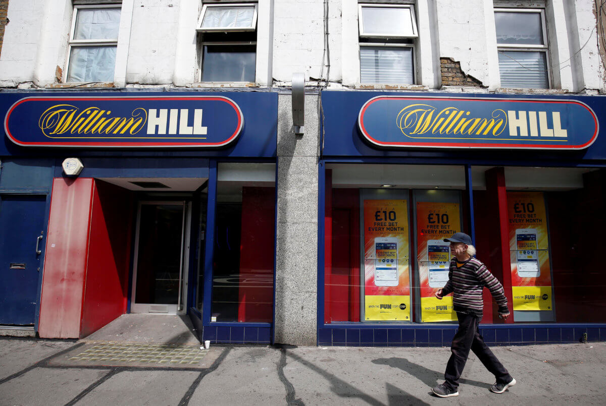 A pedestrian walks past a William Hill betting shop in London