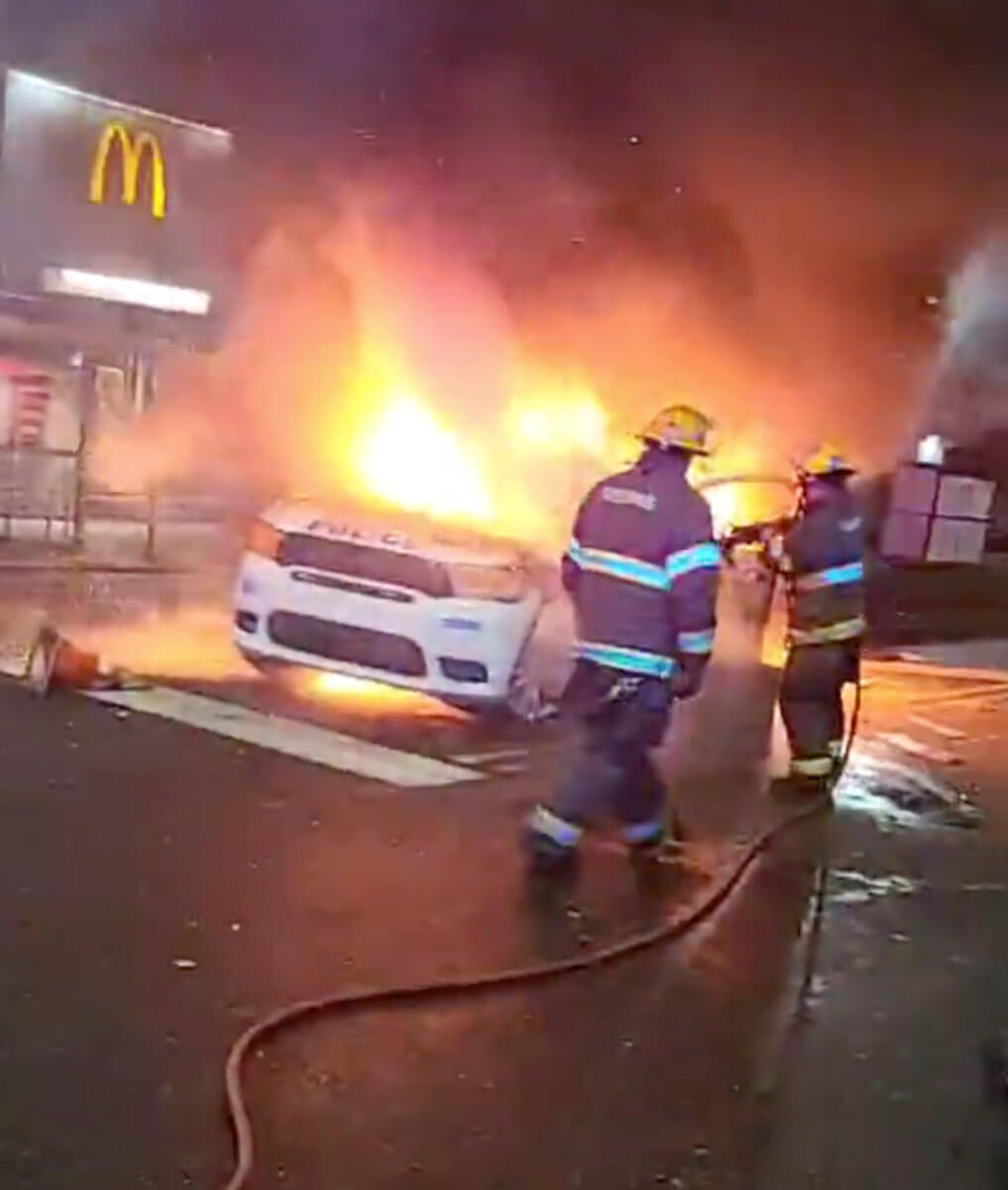 Police vehicle burns during protests after police shooting death of Wallace Jr. in Philadelphia, Pennsylvania