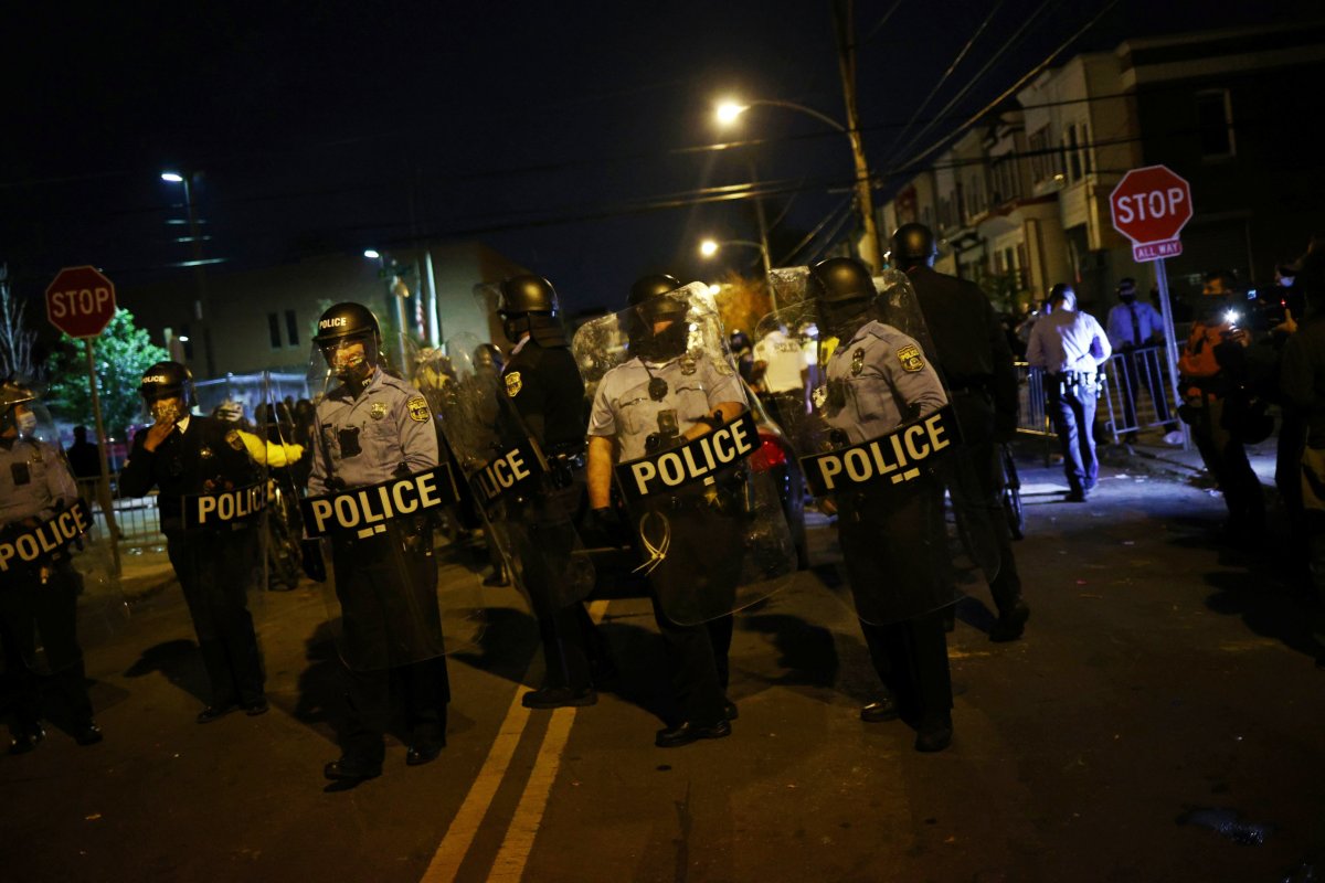 Police officers stand guard outside a police station in Philadelphia, Pennsylvania