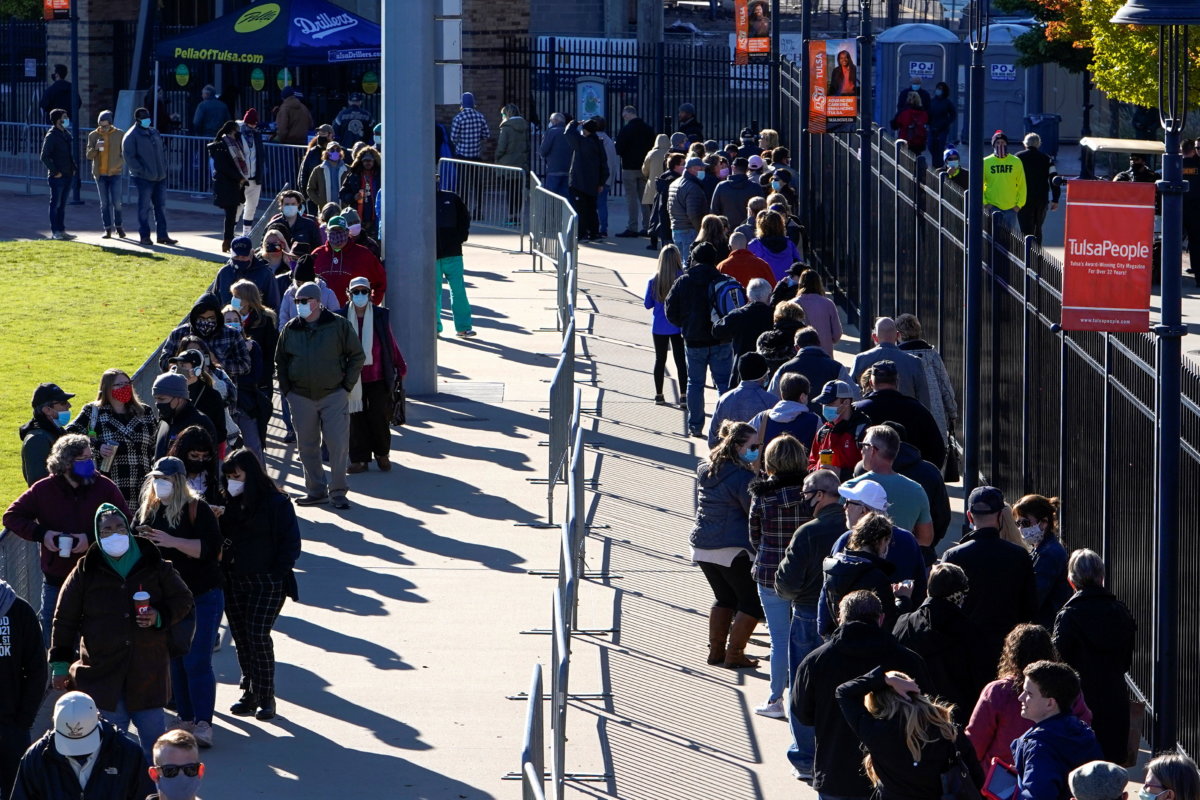 Voters wait in line to cast their ballots during early voting at ONEOK Field in Tulsa