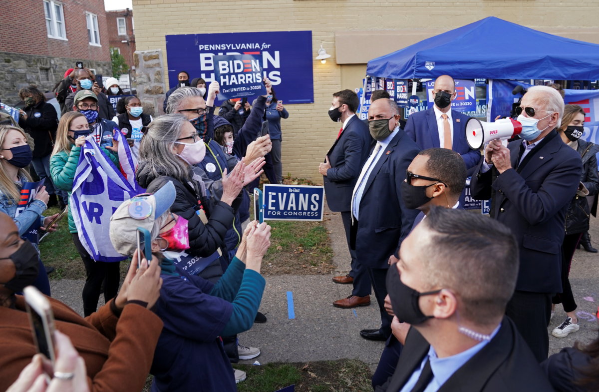 U.S. Democratic presidential nominee Joe Biden speaks through a megaphone at a canvassing stop, on Election Day in Philadelphia
