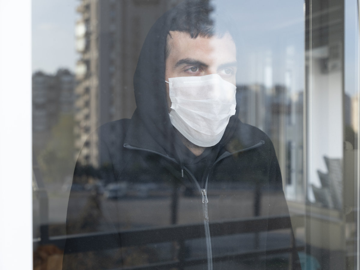 Young men isolated himself wearing a face mask quarantine himself