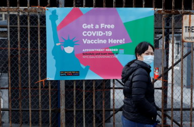 A woman arrives to line up to receive a dose of the coronavirus disease (COVID-19) vaccine at a 24 hour vaccination center at the Brooklyn Army Terminal in Brooklyn, New York
