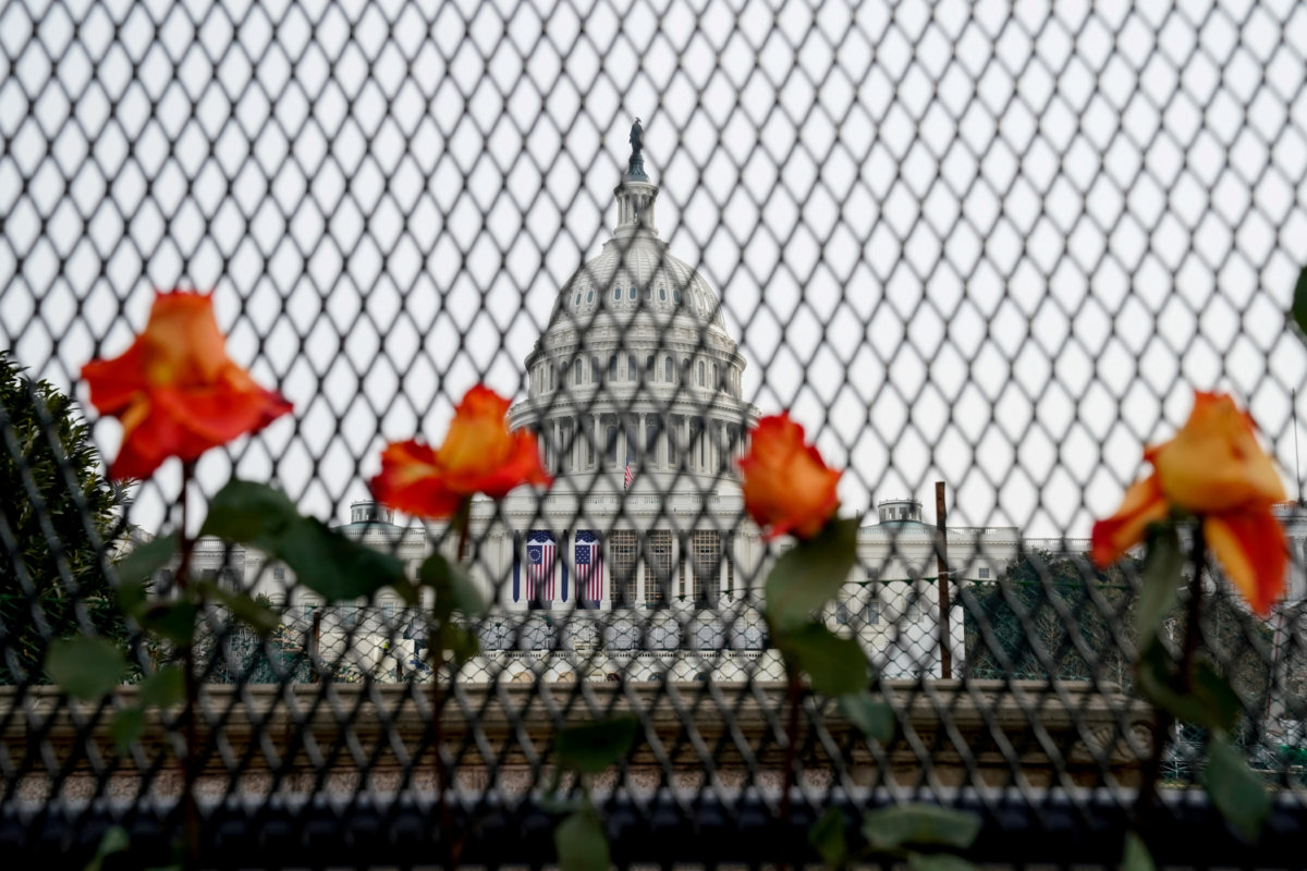 FILE PHOTO: Flowers are placed in security fencing around the U.S. Capitol days after supporters of U.S. President Donald Trump stormed the Capitol in Washington