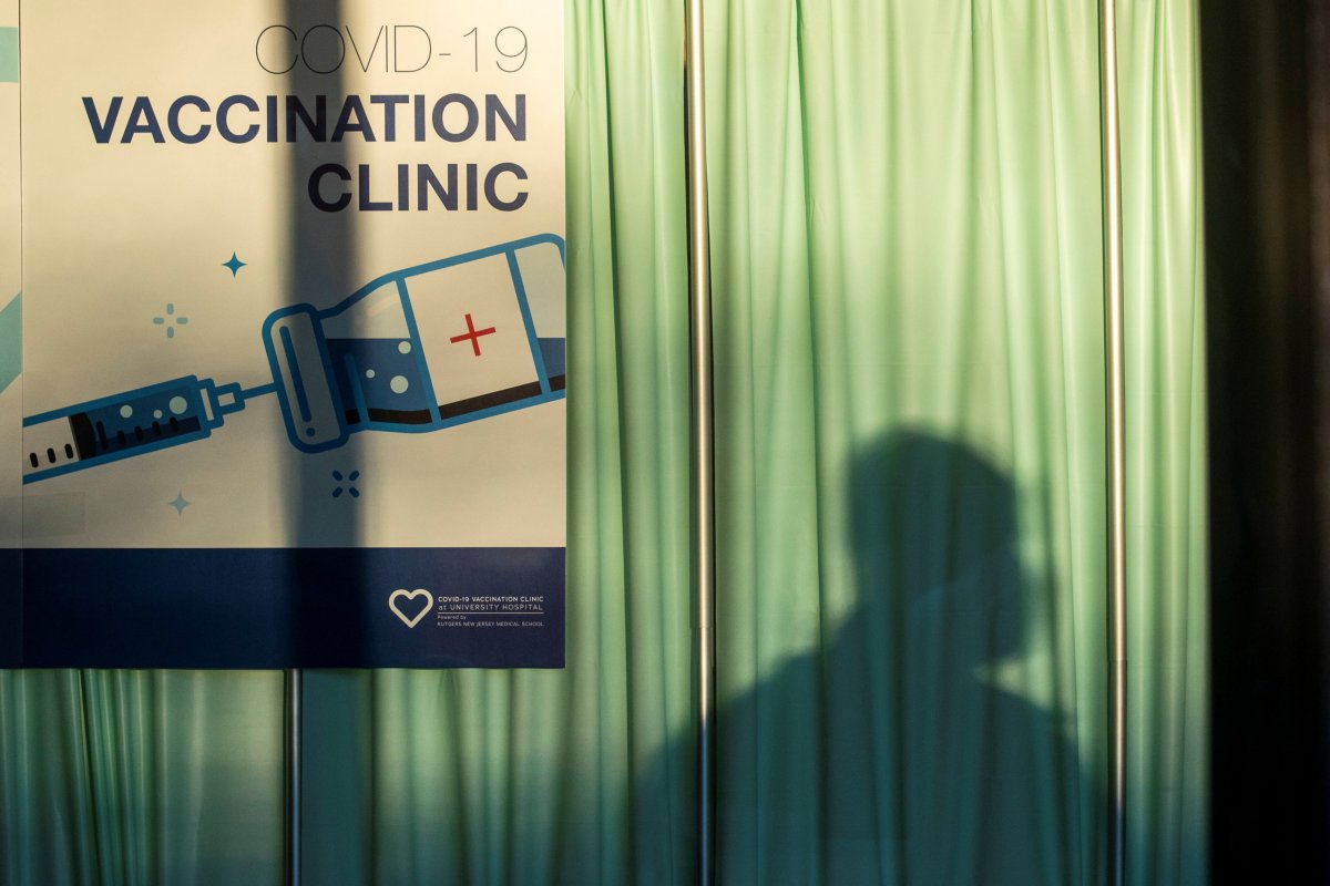 The shadow of a person is seen at the area where people get vaccine at University Hospital’s COVID-19 vaccine clinic at Rutgers New Jersey Medical School in Newark, New Jersey