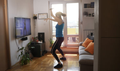 Woman exercising and watching online workout video