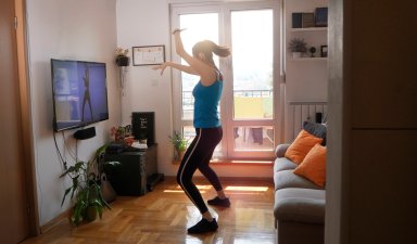 Woman exercising and watching online workout video