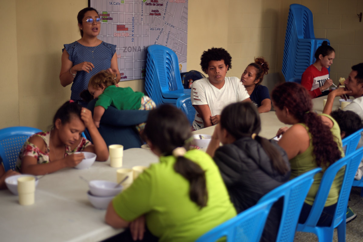 Honduran migrants, sent back to Guatemala from the U.S., sit at the table after arriving at Casa del Migrante shelter in Guatemala City