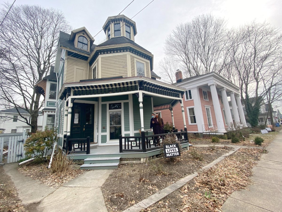 Kate and Cameron Reinhart stand at their 1880’s Octagon house in eastern Connecticut