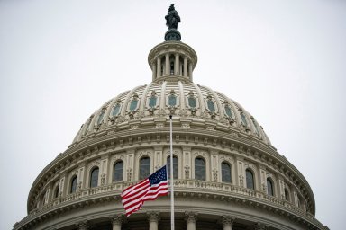 The American flag flies at half staff at the U.S. Capitol Building on the fifth day of the impeachment trial of former U.S. President Donald Trump