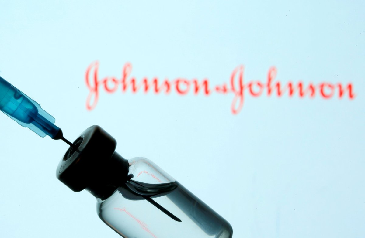 FILE PHOTO: Vial and syringe are seen in front of displayed Johnson&Johnson logo in this illustration