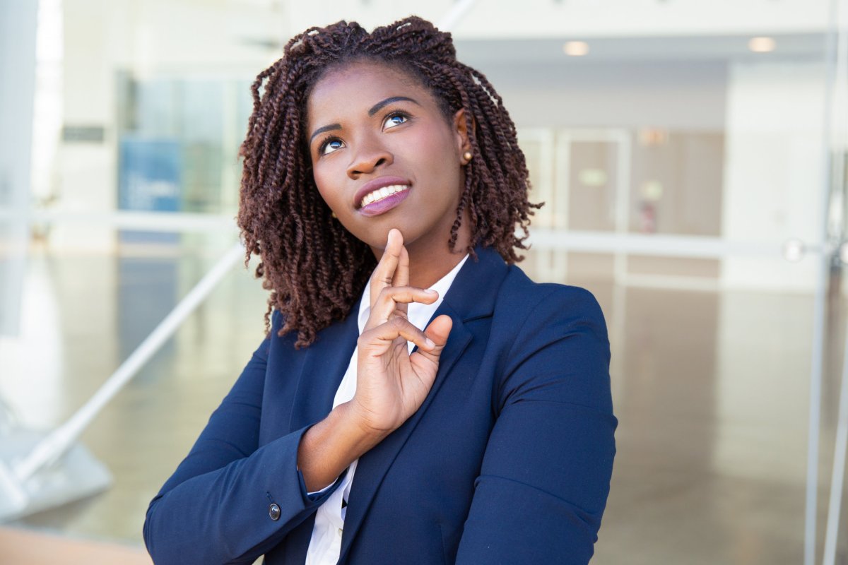 Pensive smiling professional thinking outside