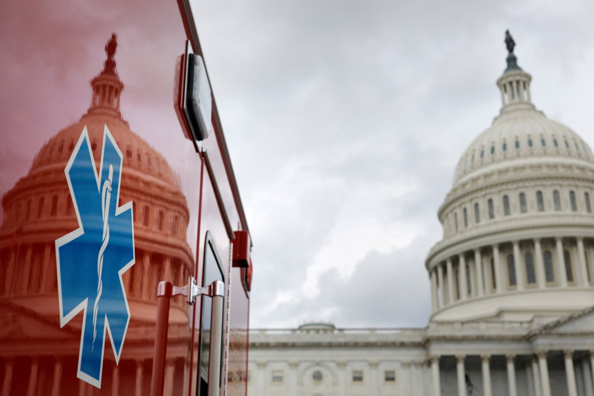 FILE PHOTO: The U.S. Capitol Building is reflected against an ambulance along the East Front on Capitol Hill in Washington