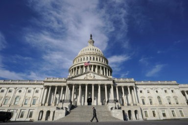 FILE PHOTO: A man walks past the U.S. Capitol in Washington