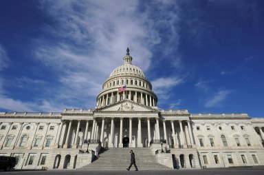 FILE PHOTO: A man walks past the U.S. Capitol in Washington