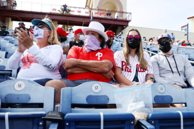 Fans enjoy a warm, sunny day during a spring training baseball game between the Pittsburgh Pirates and the Philadelphia Phillies in Clearwater, Florida