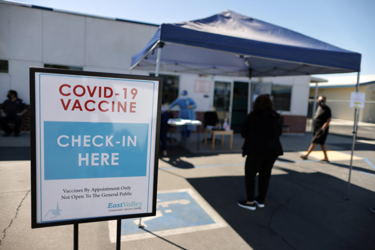 FILE PHOTO: People arrive for coronavirus disease (COVID-19) vaccinations, at East Valley Community Health Center in La Puente