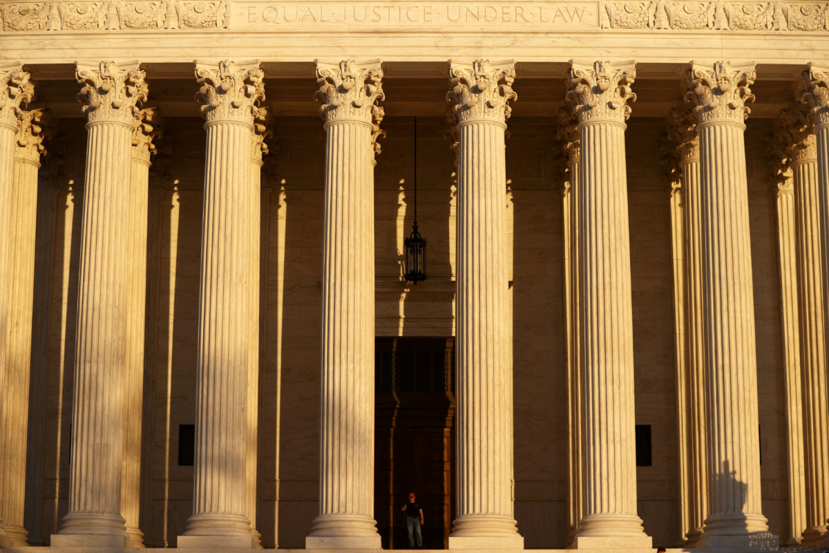 FILE PHOTO: A man walks at the U.S. Supreme Court building in Washington
