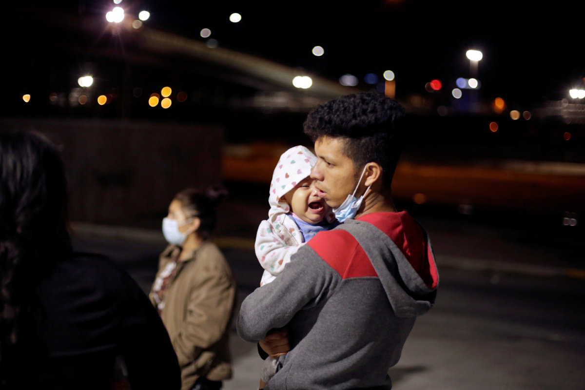 Stephanie, 10 months old, cries as she is carried by her father Manuel de Jesus Martinez, an asylum-seeking migrant from Honduras, who was airlifted from Brownsville to El Paso, Texas, and deported from the U.S. with her, in Ciudad Juarez