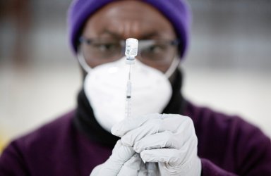 FILE PHOTO: National Guard personnel guide visitors to a mass vaccination site in Ridgefield