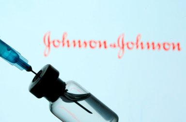 FILE PHOTO: Vial and sryinge are seen in front of displayed Johnson&Johnson logo in this illustration taken