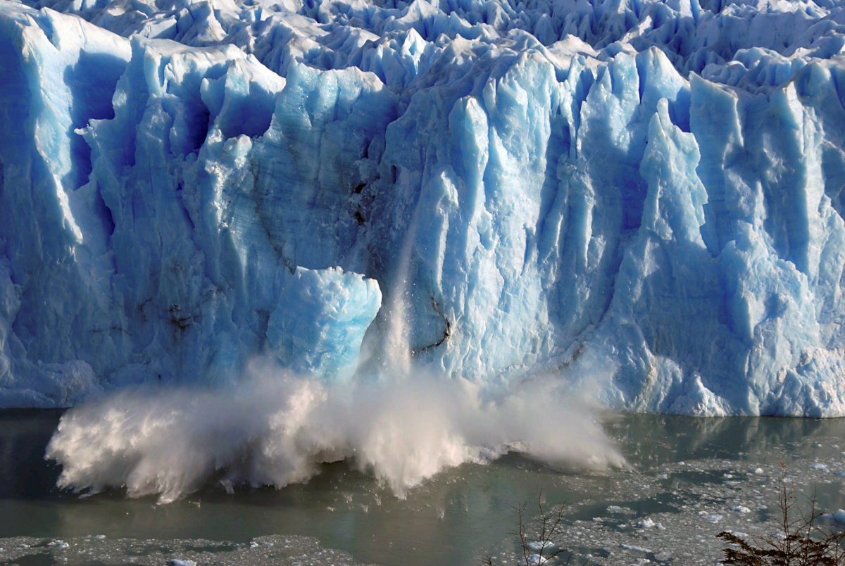 FILE PHOTO: Splinters of ice peel off from one of the sides of the Perito Moreno glacier