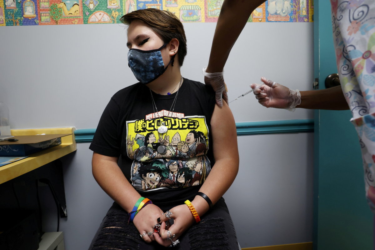 Grace Peterson, 14, is inoculated with Pfizer’s vaccine against coronavirus disease (COVID-19) after Georgia authorized the vaccine for ages over 12 years, at Dekalb Pediatric Center in Decatur