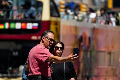 People with no masks pose for photos in New York City