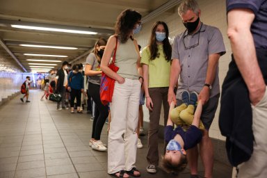 FILE PHOTO: Jane Hassebroek waits in line to receive a COVID-19 vaccination outside the American Museum of Natural History with her family in Manhattan