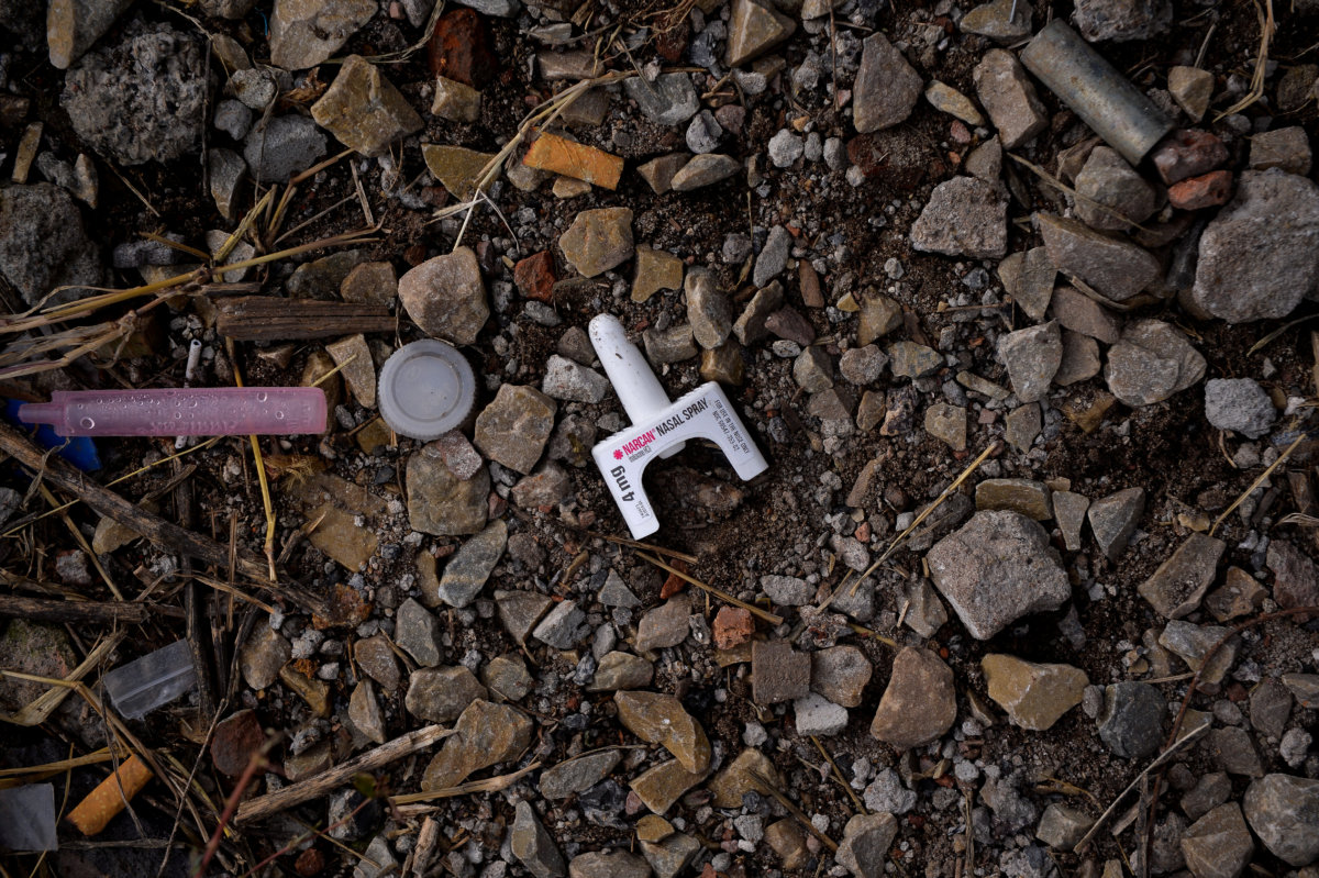 A used container of the anti-overdose drug Narcan lies on the ground in a park in the Kensington section of Philadelphia